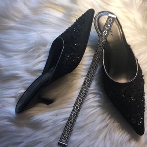 Black sequined mules.